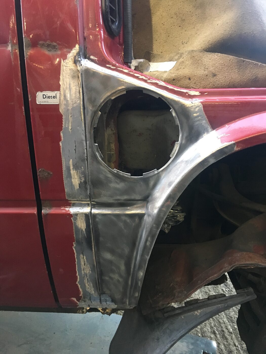 New steel repair section welded into the wheel arch, ground back and primed
